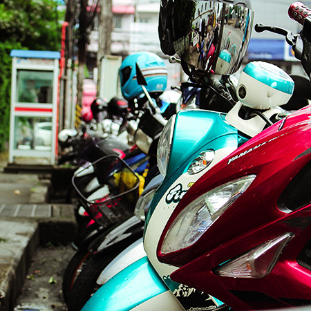 colourful scooters lined up on a street